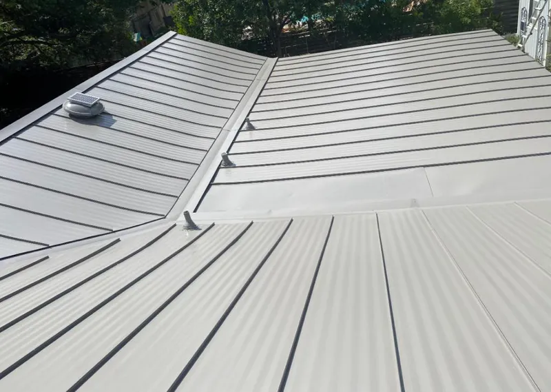 Solar attic fan installed on a metal roof for Roof Ventilation in South Haven